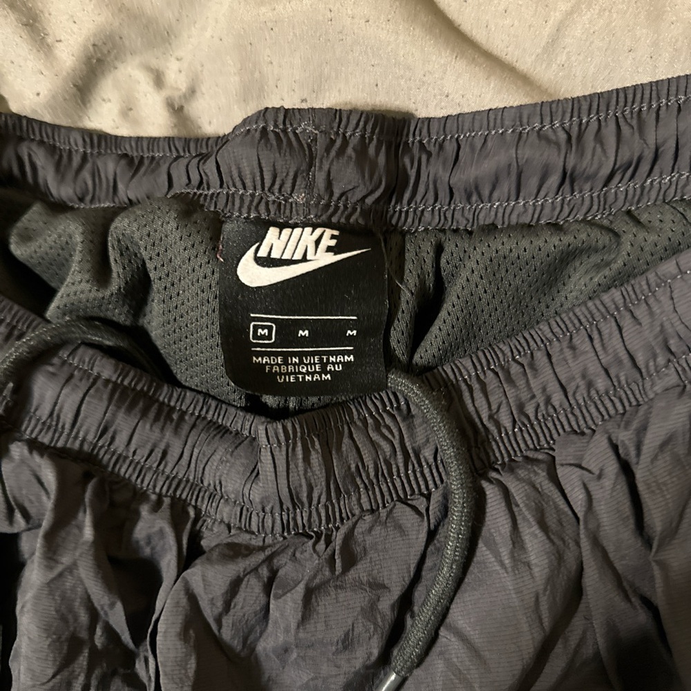 Nike sweatpants. Double lined with pockets, zippers on ankles, drawstring.